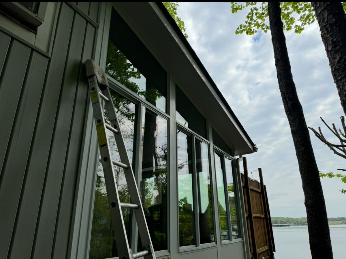 Ladder against a lakefront porch with the lake behind