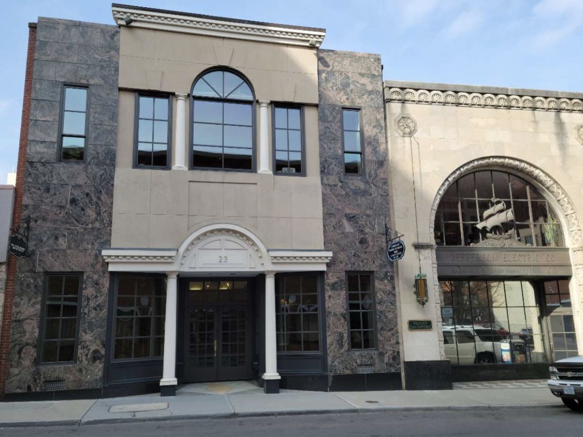Downtown storefront building with arched and divided-light windows