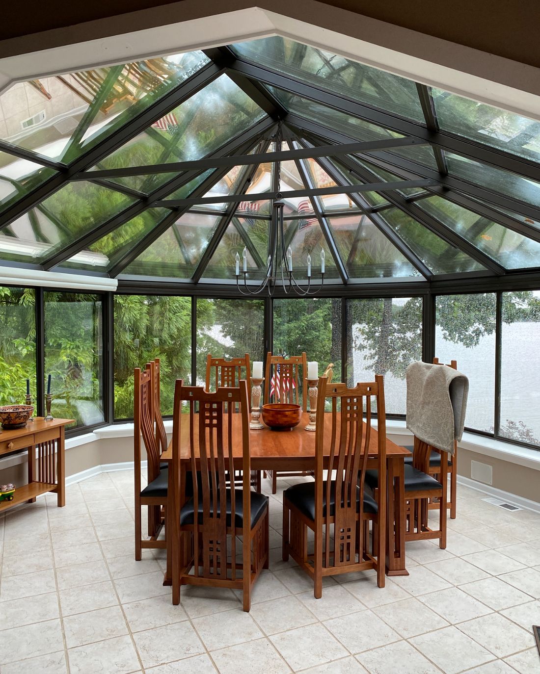 Glass-roofed sunroom with a dining table, freshly cleaned